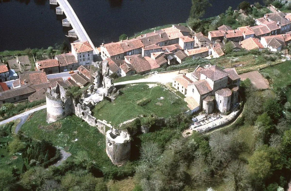 The ruined round towers of the castle at Saint-Germain-de-Confolens seen from the air, above the village roofs and the river