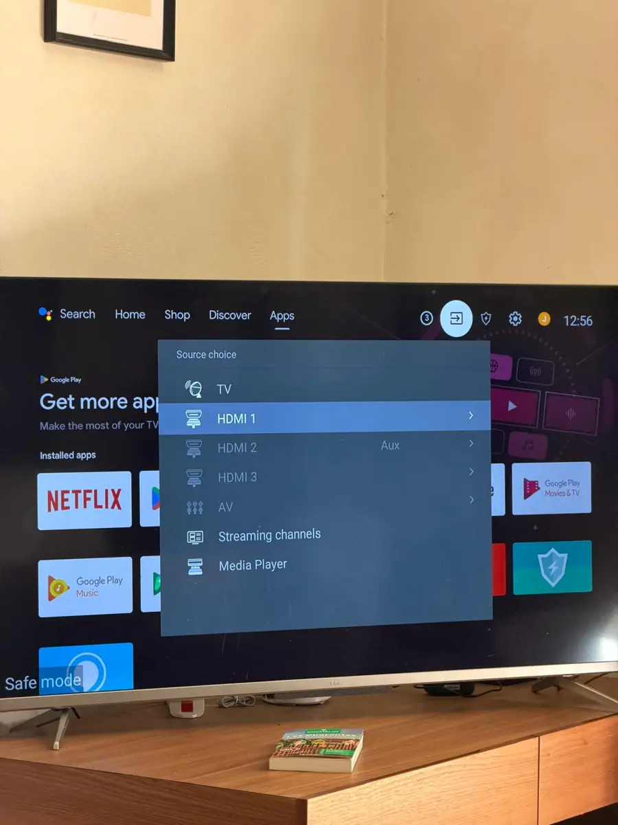 The TV&rsquo;s source menu open over the home screen, with HDMI 1 highlighted